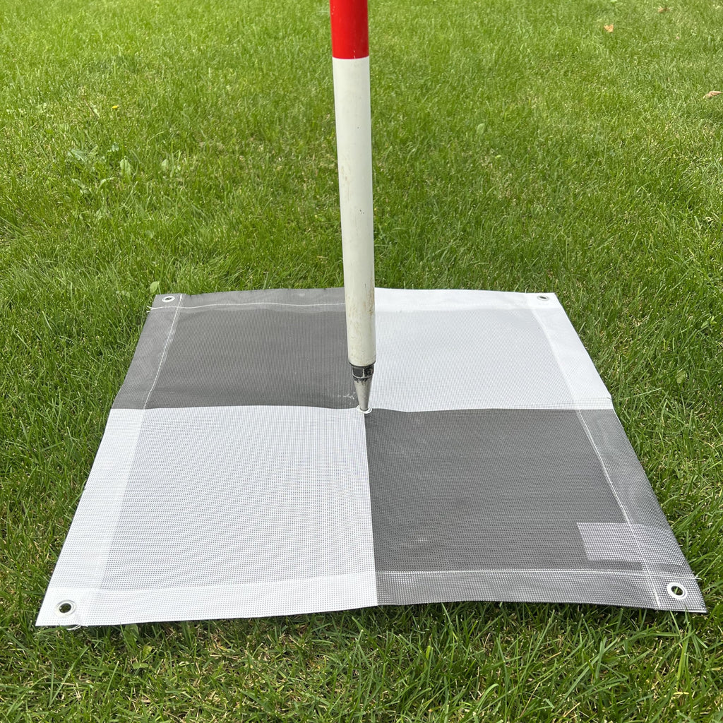 2x2 checkerboard GCP target staked in the field for drone surveying